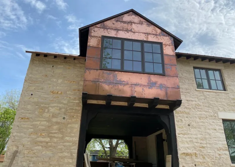Copper metal panel facade on a stone building for Roof Repair in Snowflake