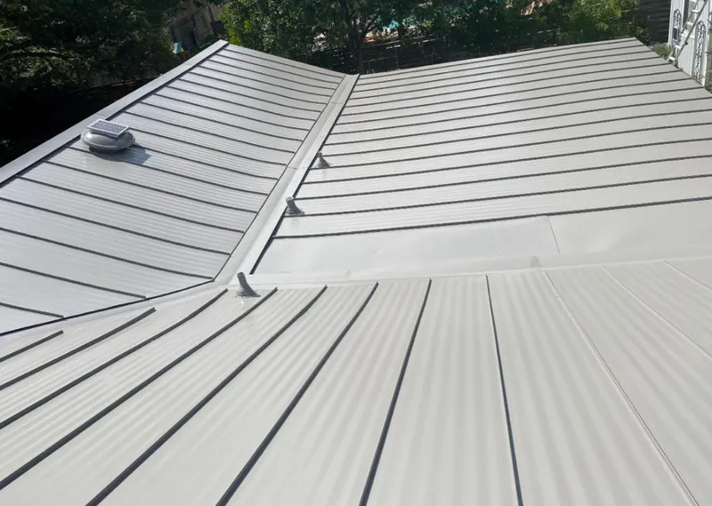 Solar attic fan installed on a metal roof for Roof Ventilation in Snowflake