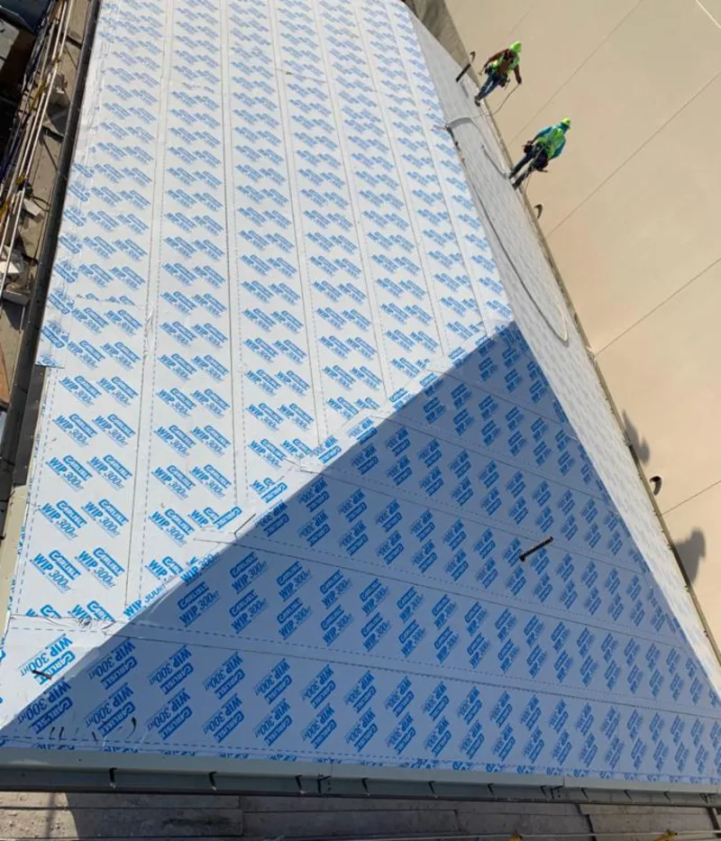 Professional roofers installing underlayment on a metal roof in Snowflake